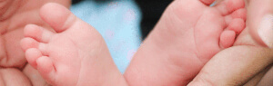osteopathy-hands-with-baby-feet-300x95px